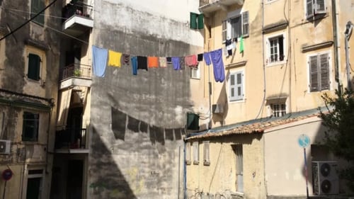 Residential Building with Laundry Hanging in Sunny Courtyard