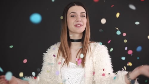 Young Woman Smiling as Confetti Falls