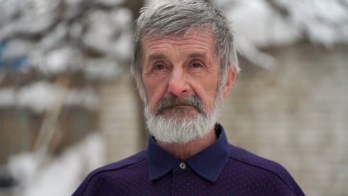 Man Waving Hand Outside in Winter Snow