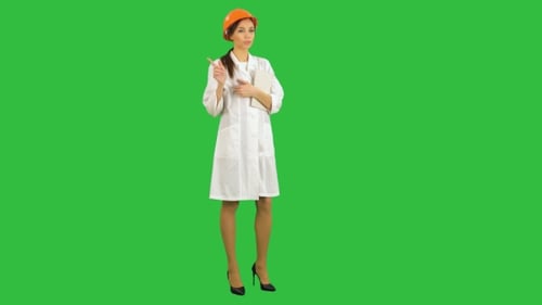 Female Construction Supervisor in Hardhat Holding Tablet Talking To Camera on a Green Screen, Chroma