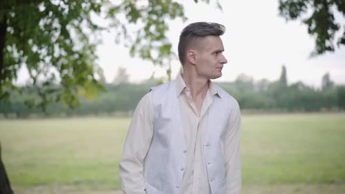 Portrait of Nervous Dissatisfied Boyfriend Waiting for Girlfriend in Summer Park. Unhappy Stressed