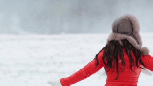 Young Woman Runs Joyfully in Winter Wonderland
