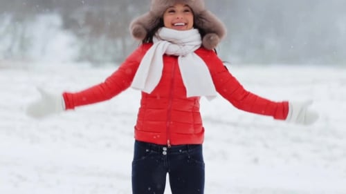 Cheerful Woman Playing in Winter Snow