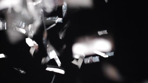 Silver Confetti Falling on Black Background