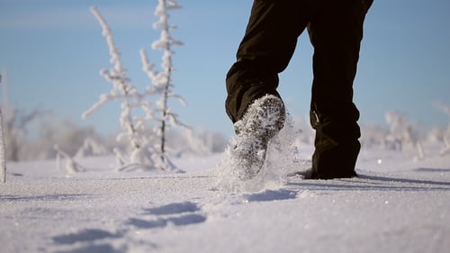 Person Walking, Leaving Footprints in Sparkling Snow