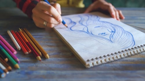 Artist Drawing Portrait with Colored Pencil