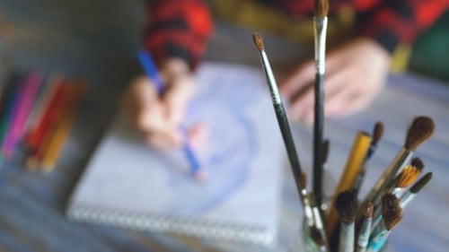 Artist Drawing with Pencil on Sketchpad