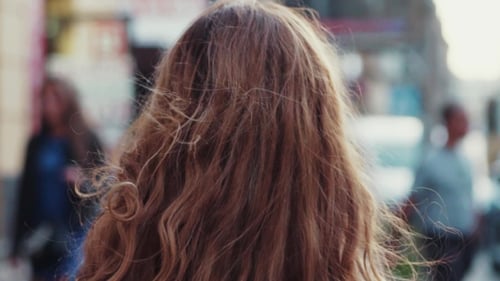 Smiling Woman With Red Hair On City Street
