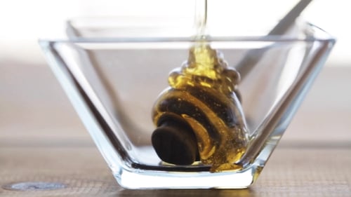 Honey in Glass Bowl and Dipper on Table 22