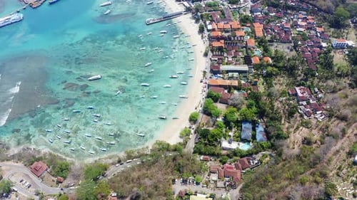 Drone Shot of Sunny Coast in Bali Indonesia with Crystal Clear Waters and Boats