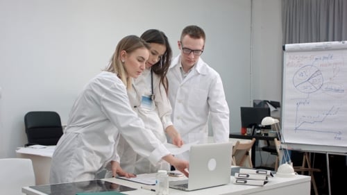 Team of Doctors Working on Laptop and Analyzing Xray in Medical Office
