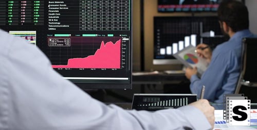 Analysts Reviewing Financial Data on Computer Monitors