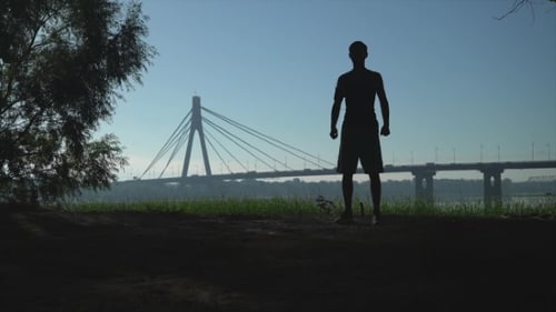 Silhouette of Adult Stretching Arms Outdoors