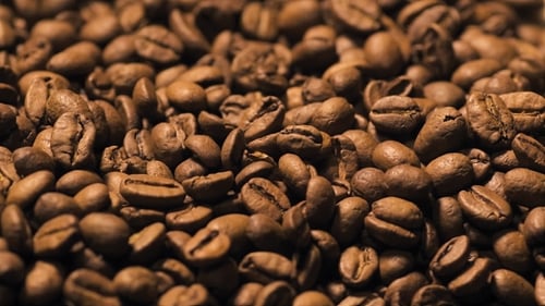 Roasted Coffee Beans Piling on Burlap Surface