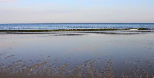 Calm Beach Scene with Gentle Waves Rolling
