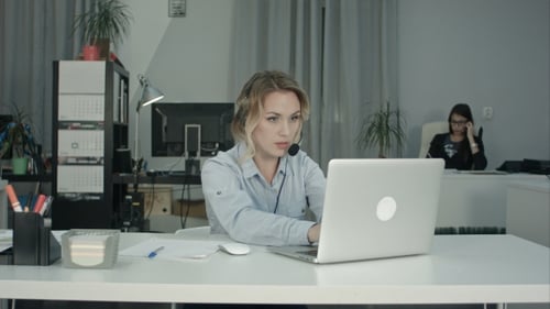 Customer Support Operator Working in a Call Center Office