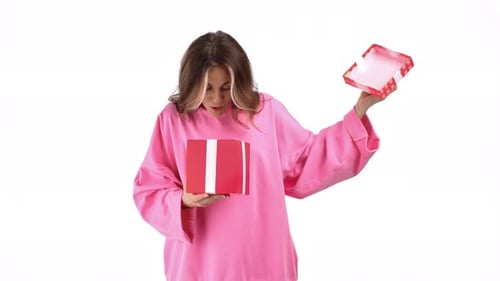 Woman Opens Birthday Gift with Joyful Smile