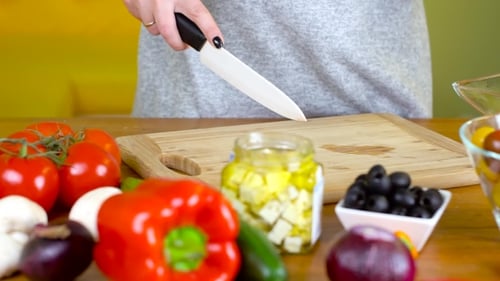 Woman Prepares Colorful Salad with Fresh Vegetables