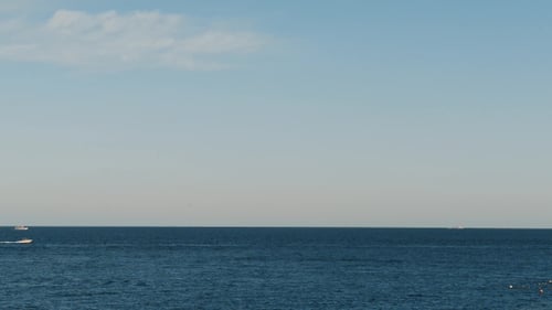Boat in the Sea. Ship in the Sea. Beautiful Evening Landscape of Sea and Mountains. Evening View of