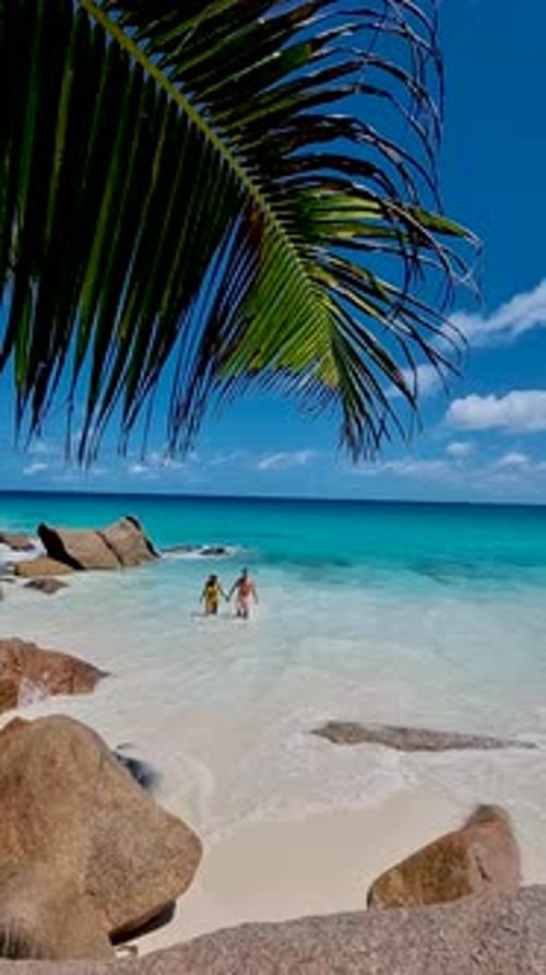 Anse Georgette Praslin Seychelles Young Couple Men and Woman on a Tropical Beach During a Luxury