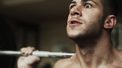 Muscular Man Lifting Heavy Weights