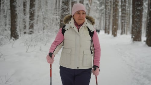 Woman Nordic Walking in Snowy Winter Forest