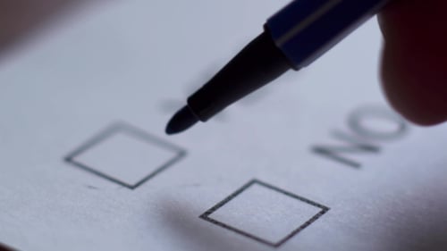 Cropped of Businesswoman Writing on Checklist