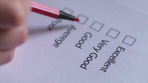 Cropped of Businesswoman Writing on Checklist