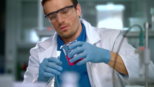 Scientist Mixing Chemicals in Lab Experiment