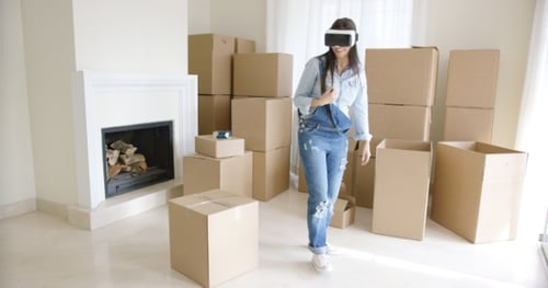 Woman Wearing VR Headset in Room with Boxes