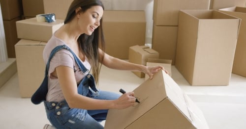 Attractive Woman Moving House and Packing
