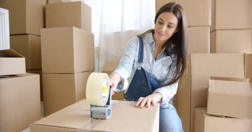 Woman Packing Boxes for Moving Day