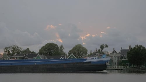 Barge Sailing By the Village Houses
