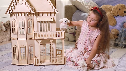 Girl Playing with Dollhouse and Stuffed Puppy Toys
