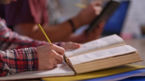 Students Studying Together with Book and Tablet