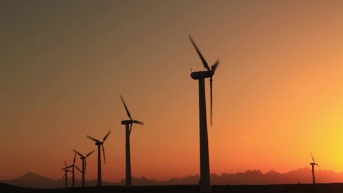 Wind Turbines at Sunset Sky Background