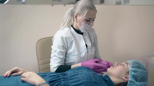 Beautician Doing Eyebrow Procedure on Client