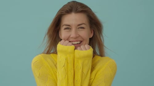 Woman in Yellow Laughing Happily