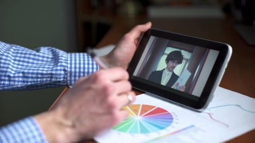 Man Analyzes Charts While Watching Business Video