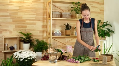 Salesman in a Flower Shop, She Unpacks Roses, Preparing Flowers for Making Festive Bouquets, Flowers