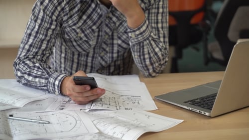 Worker in Creative Agency Holding Smartphone