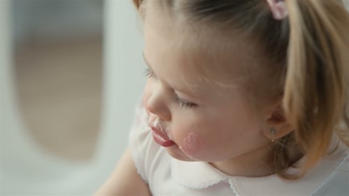 Cute Baby with a Spoon Eating Birthday Cake
