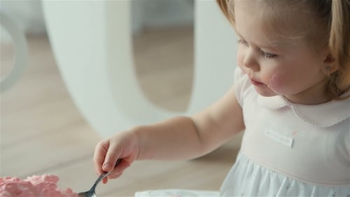 Cute Girl Eating Cake on Her Birthday