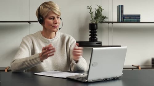 Woman Attends Virtual Meeting and Takes Notes