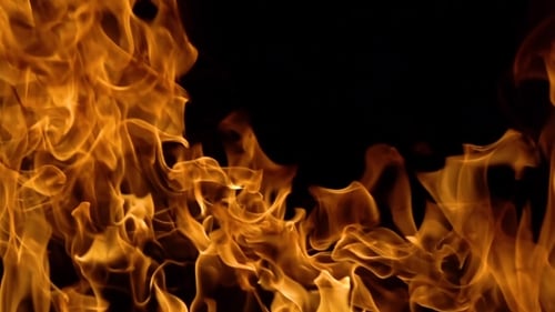 Golden Fire Flames on Black Background