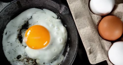 The Egg Is Fried in Hot Oil with Air Bubbles.
