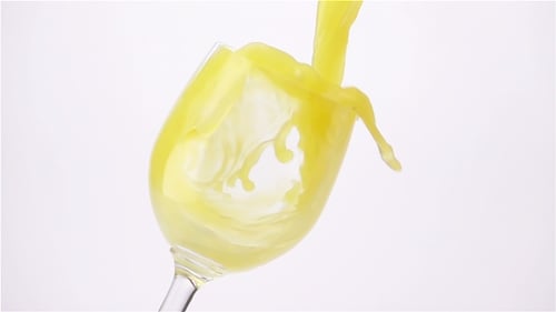 Bright Yellow Liquid Poured into a Glass