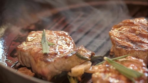 Juicy Steaks Sizzling on a Grill Pan