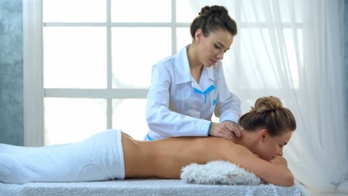 Woman Having Massage of Body in the Spa Salon.