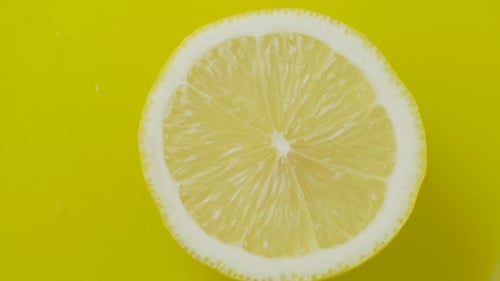 Close Up Half Slice of Lemon on Yellow
